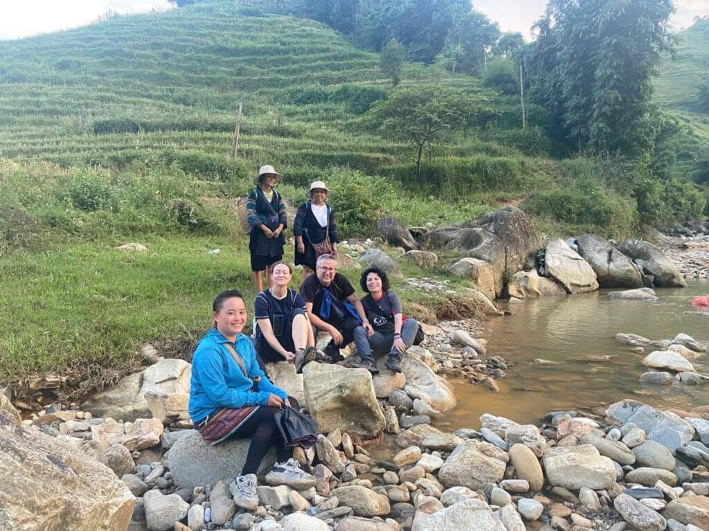 This picture captures a traveler standing at a viewpoint in Sapa, admiring the vast rice terraces and the surrounding mountain scenery. It highlights the peaceful and immersive experience of a one-day trekking tour in Northern Vietnam with Trekking Sa Pa Chu.
