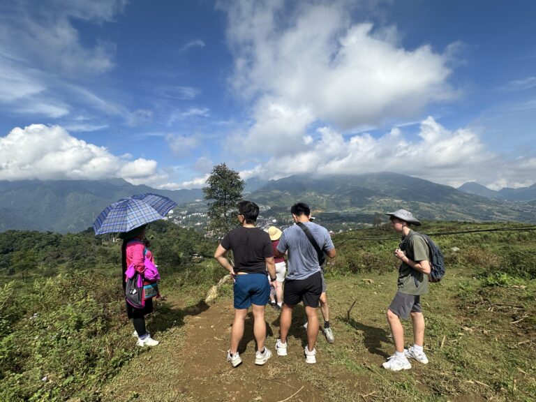 Tourists trekking in Sa Seng, Sapa with panoramic mountain views and rice terraces