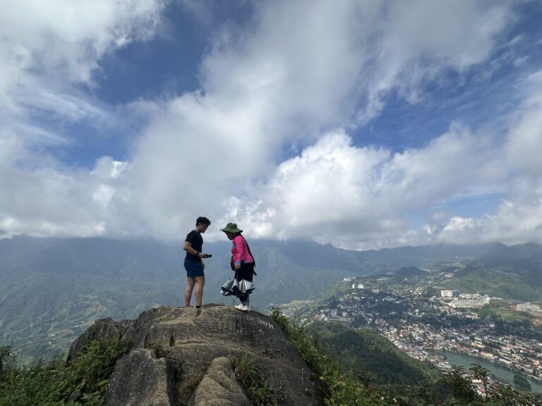 Trekking in Sapa – Hikers enjoying panoramic mountain views from the ridge