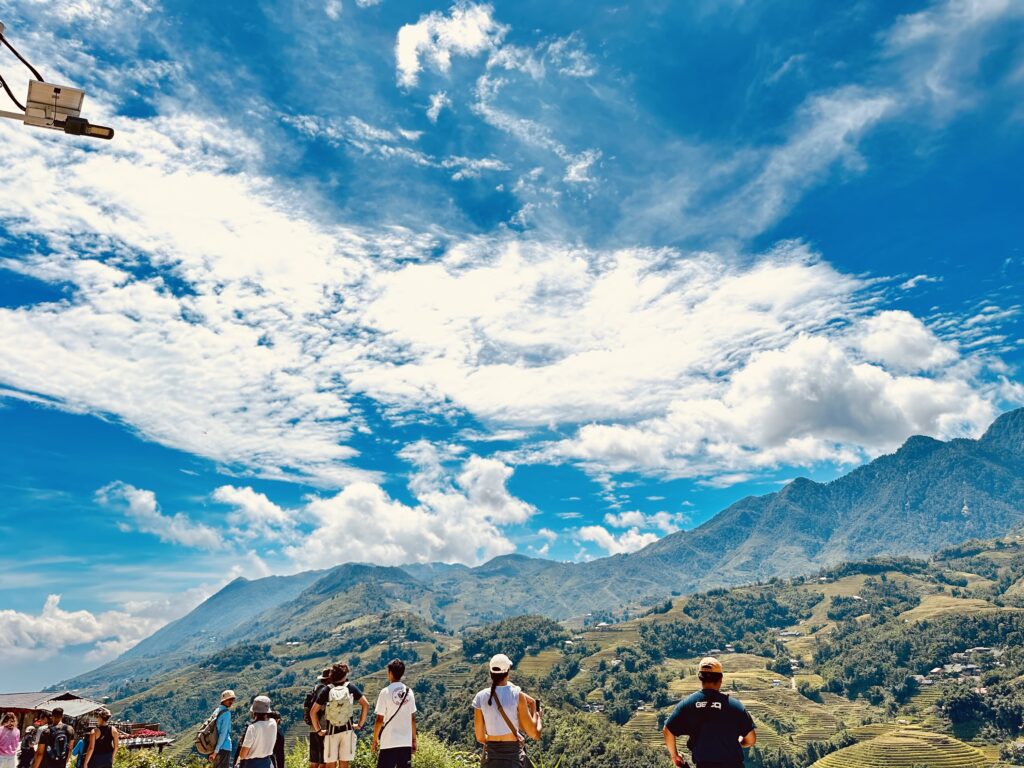 This image captures travelers walking along the rice terraces and scenic mountain paths of Sapa. Part of the 1-day trekking tour with Trekking Sa Pa Chu, it offers visitors a chance to immerse in local culture, nature, and the breathtaking Muong Hoa valley landscapes.