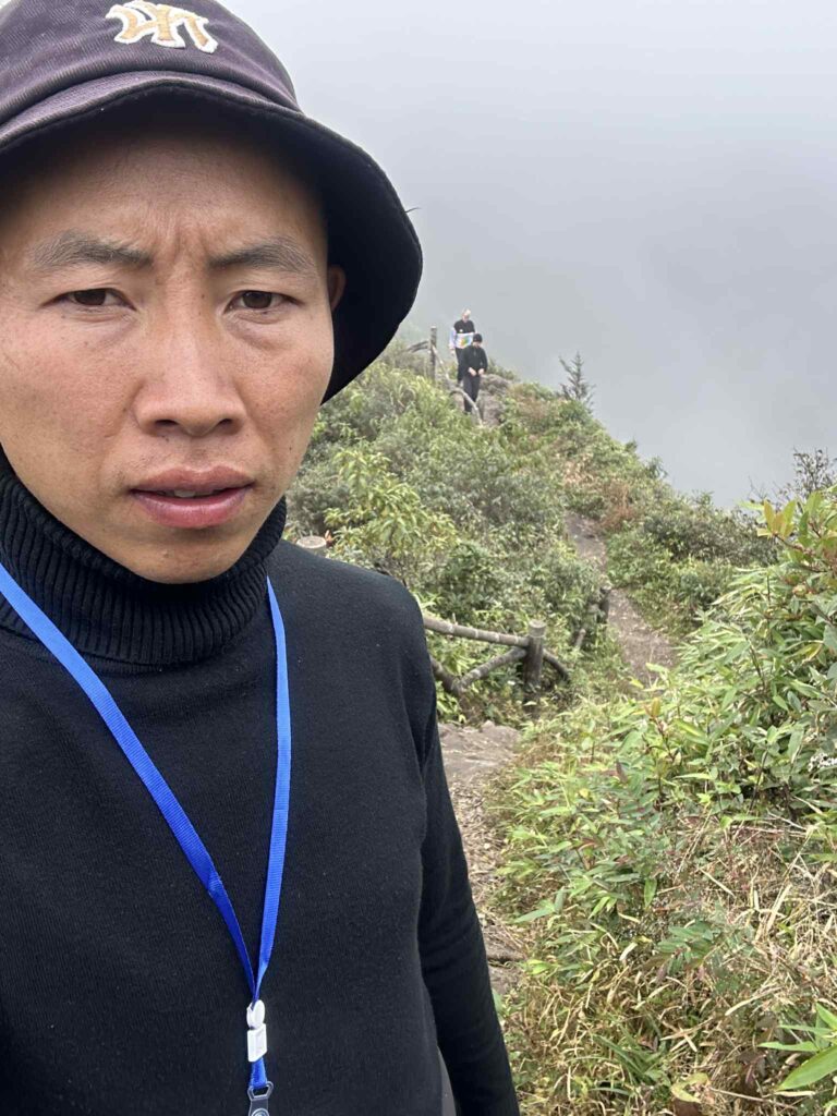 Trekker on the Fansipan mountain trail during the journey to the summit.